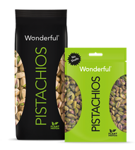 Black package of Wonderful Pistachios with shells and green package of Wonderful Pistachios with no shells